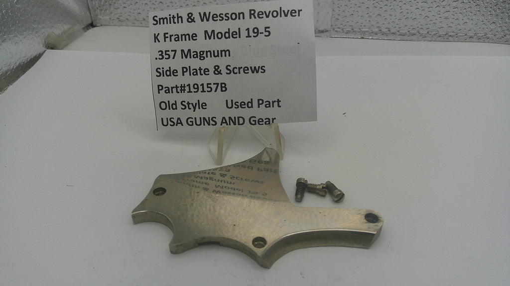 Smith & Wesson revolver side plate and screws on a white surface with a label.