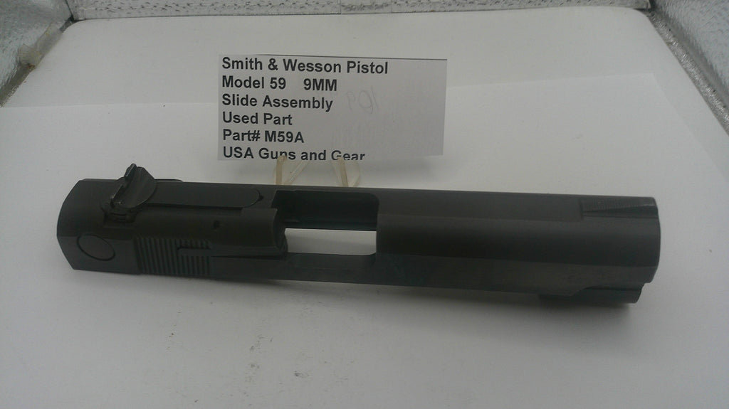 Smith & Wesson pistol slide assembly on a white surface with text label