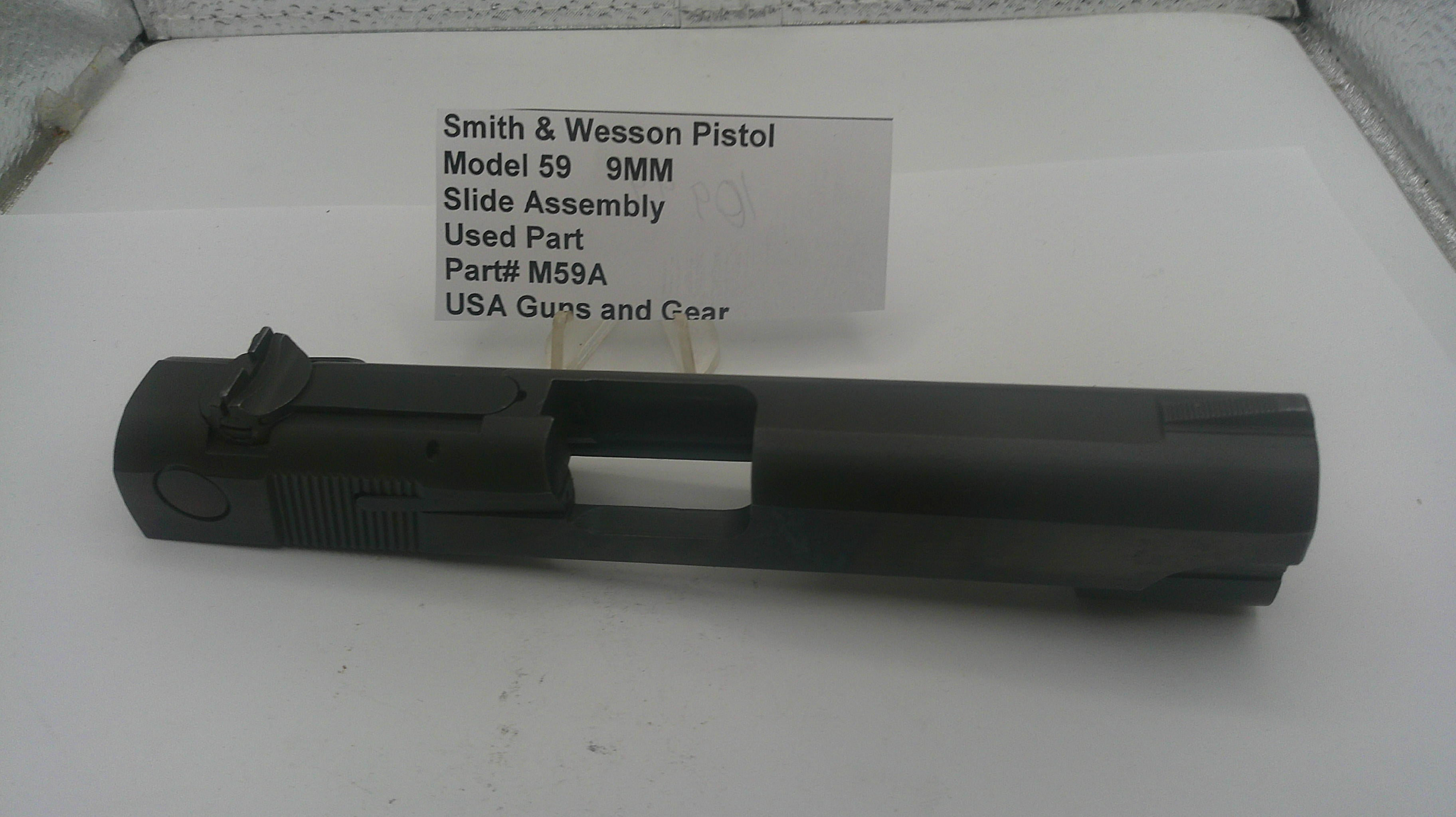Smith & Wesson pistol slide assembly on a white surface with text label