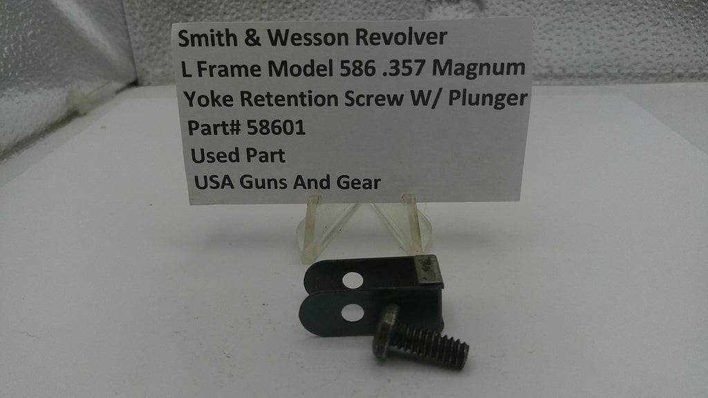 Yoke retention screw with plunger and label for Smith & Wesson Revolver on a white surface.