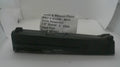 A used black Smith & Wesson pistol slide assembly, part number MP932, displayed on a white surface with a white paper label card behind it.