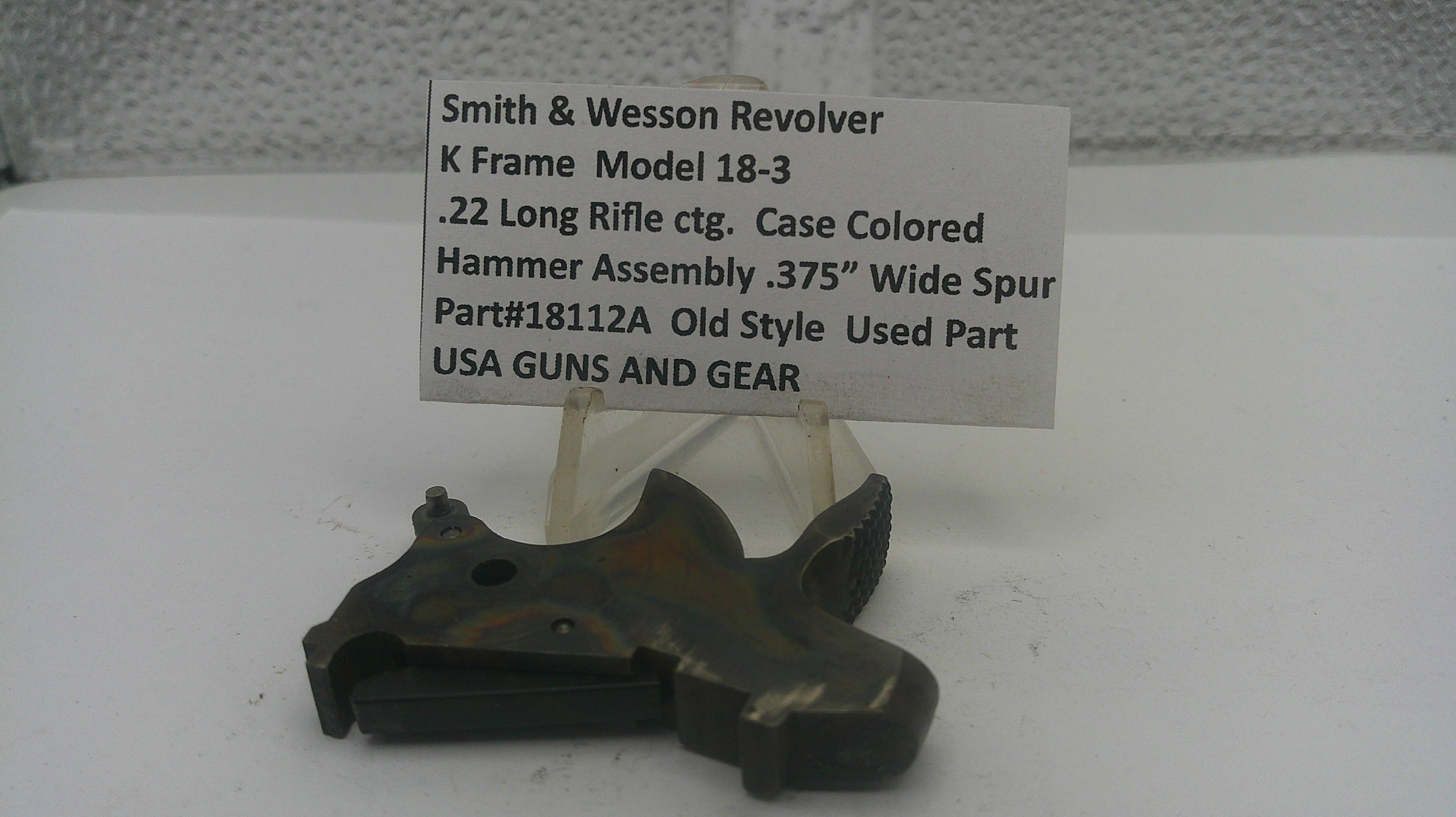 Smith & Wesson revolver hammer assembly on a white background with a label.
