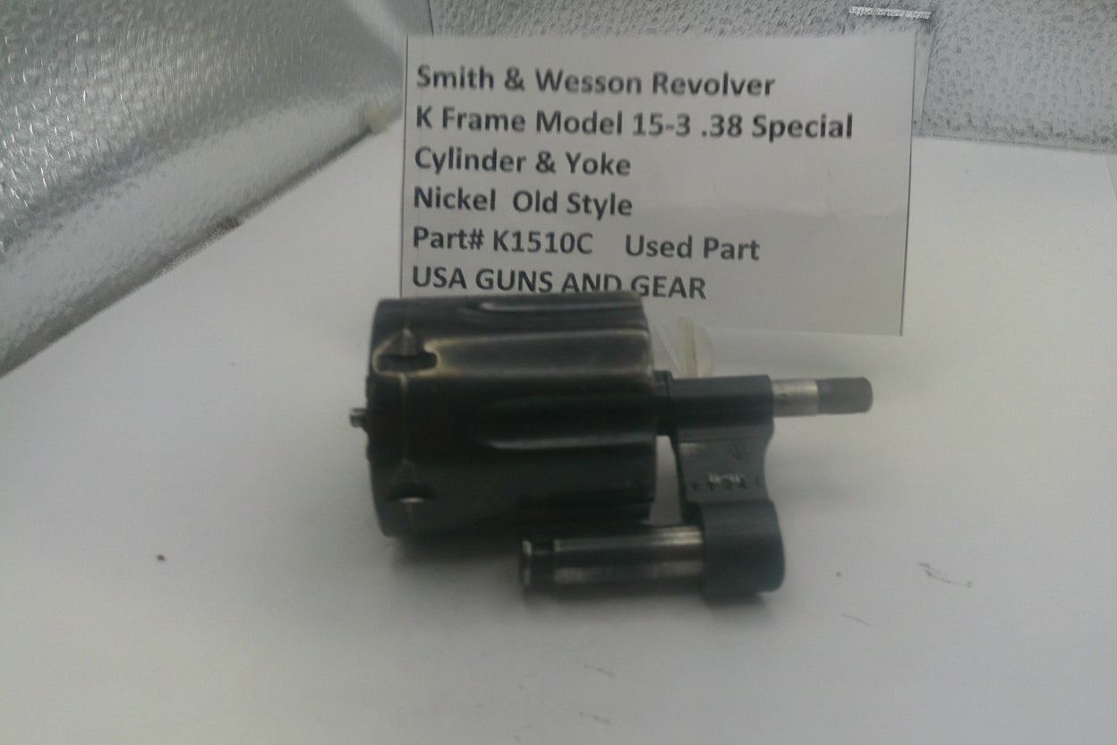 Smith & Wesson revolver cylinder and yoke on a white surface with a label.
