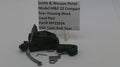 Smith & Wesson pistol part with a label on a white background