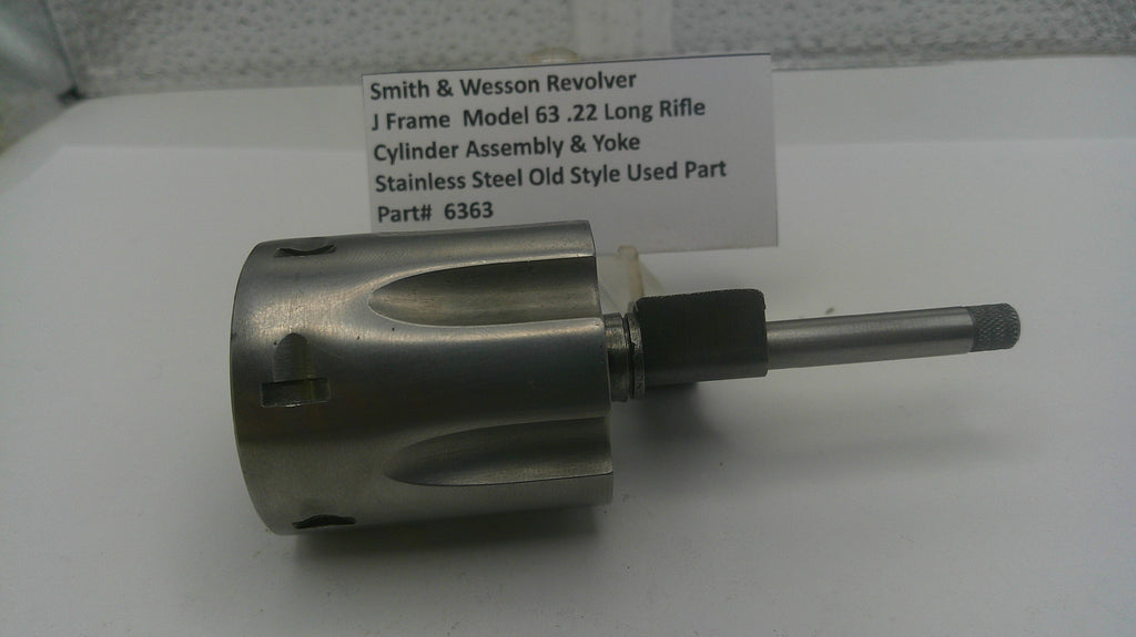 Smith & Wesson revolver cylinder assembly and yoke on a white background with a label.