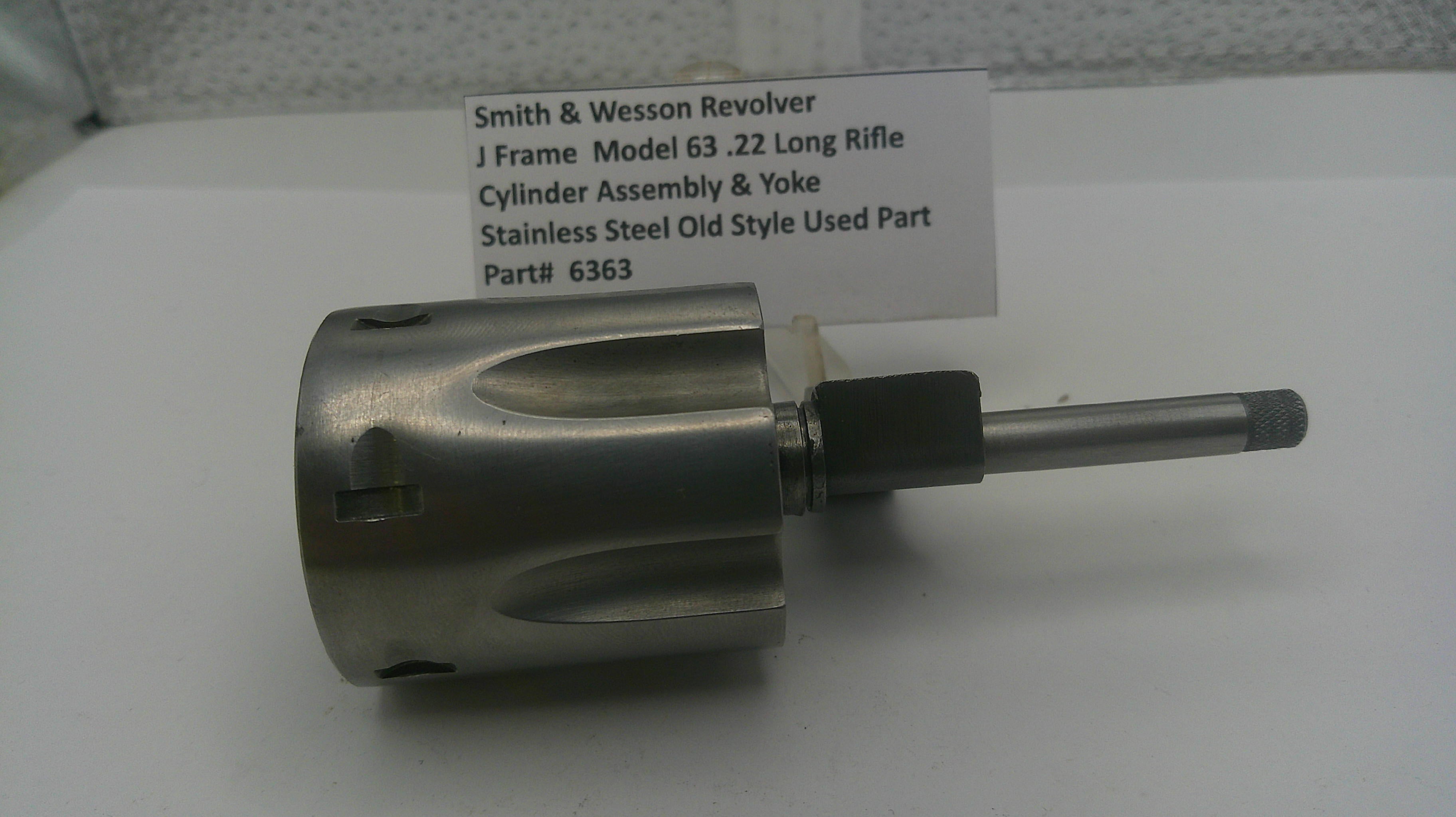 Smith & Wesson revolver cylinder assembly and yoke on a white background with a label.