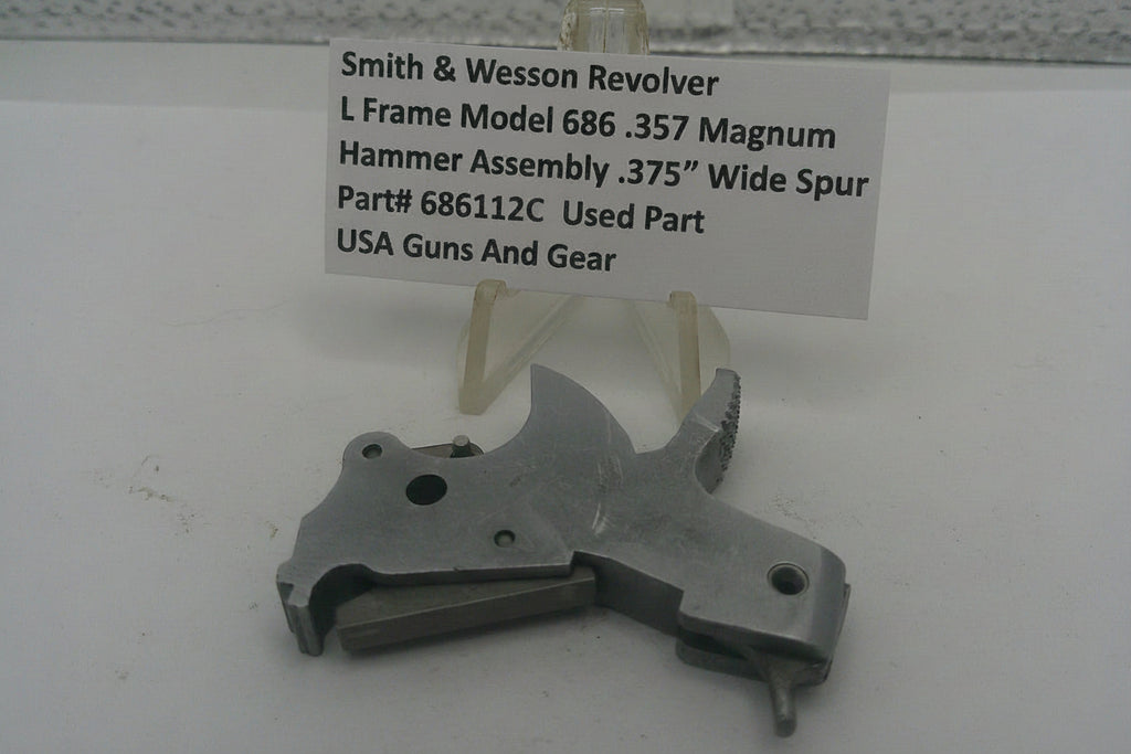 Smith & Wesson Revolver L Frame Model 686 .357 Magnum hammer assembly on a white background with a label.