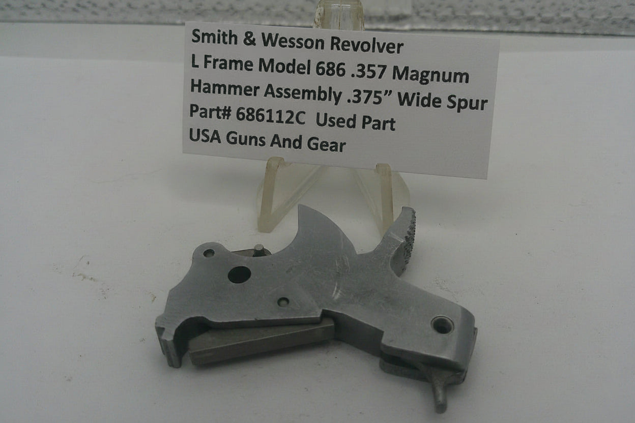 Smith & Wesson Revolver L Frame Model 686 .357 Magnum hammer assembly on a white background with a label.