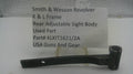 A used black metal sight body part for a Smith & Wesson revolver, displayed on a small stand in front of a white card with product details.