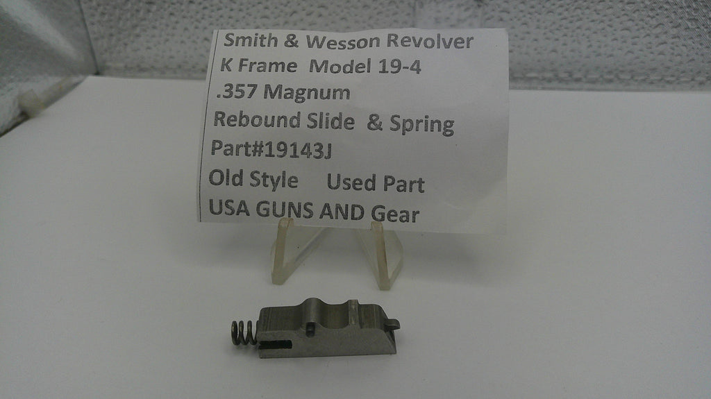 Smith & Wesson revolver part with descriptive card on a white surface