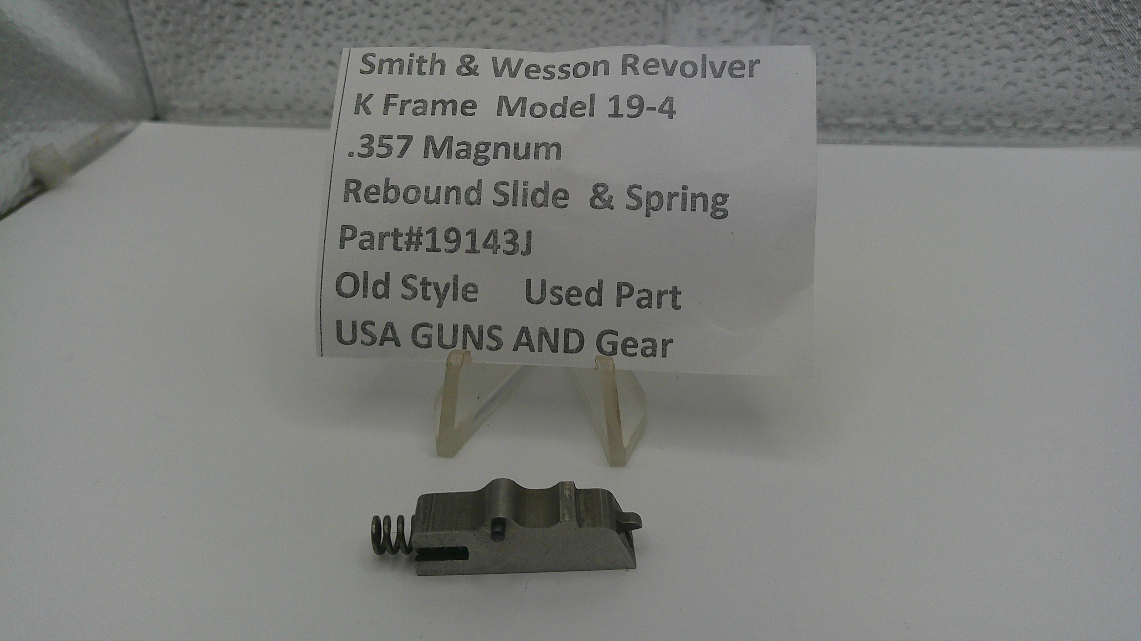 Smith & Wesson revolver part with descriptive card on a white surface