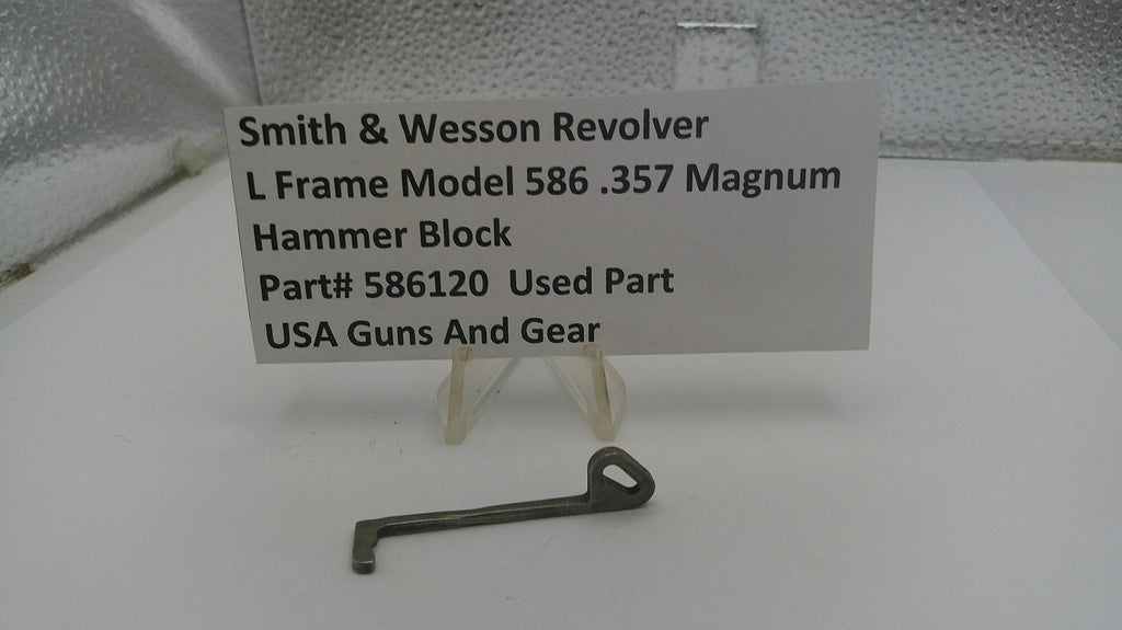 Smith & Wesson revolver hammer block part with a label on a white background