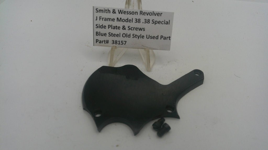 Black side plate for a Smith & Wesson revolver on a white background with a label.
