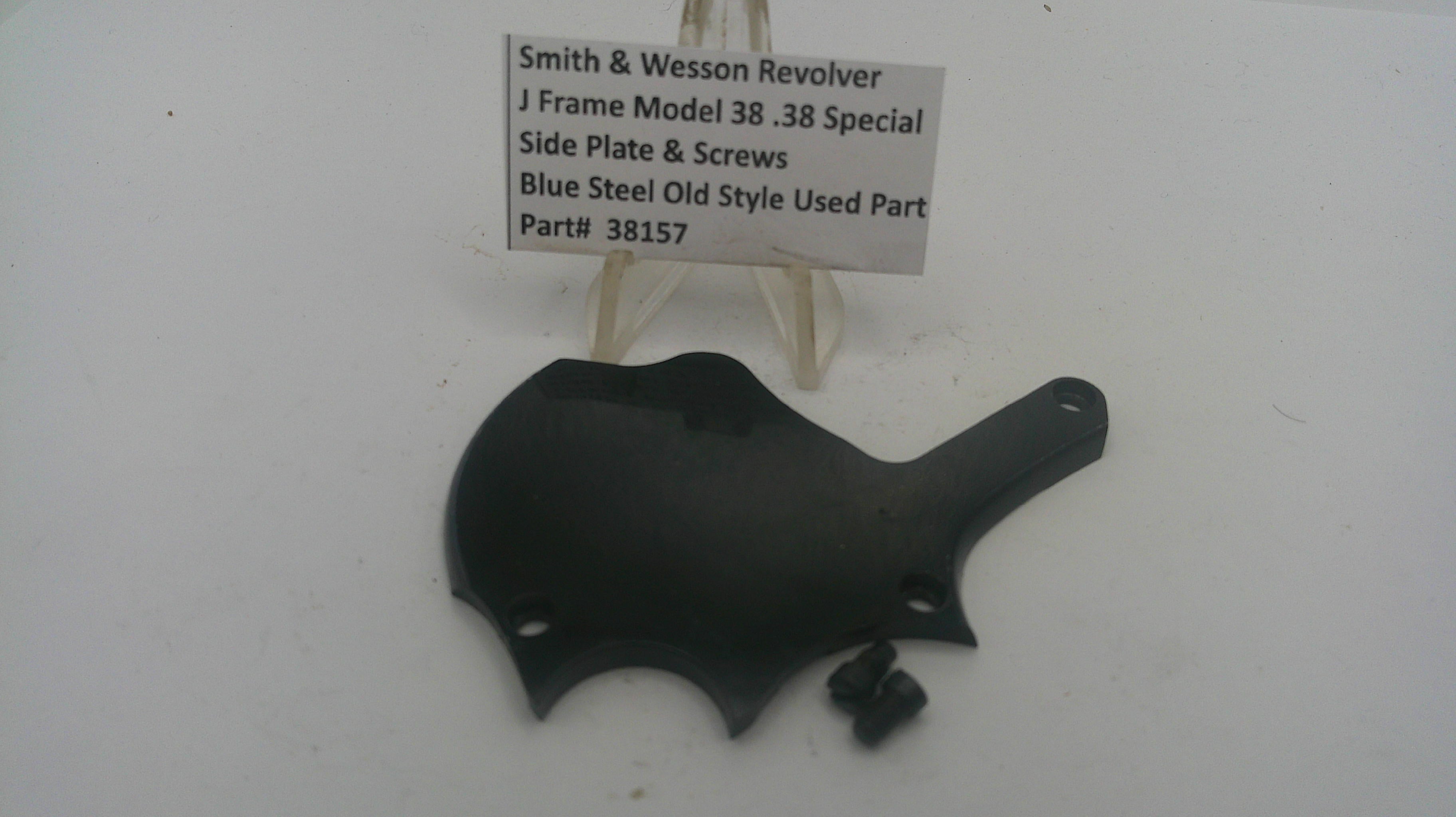 Black side plate for a Smith & Wesson revolver on a white background with a label.