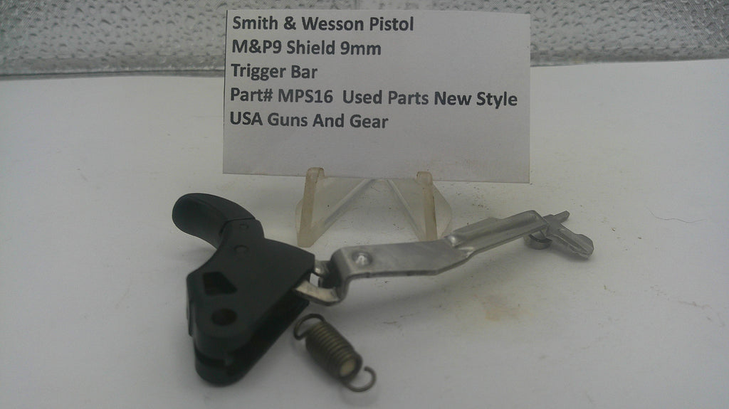 Smith & Wesson M&P9 Shield 9mm pistol trigger bar replacement part, part number MPS16, shown on a white display stand with a handwritten label card.