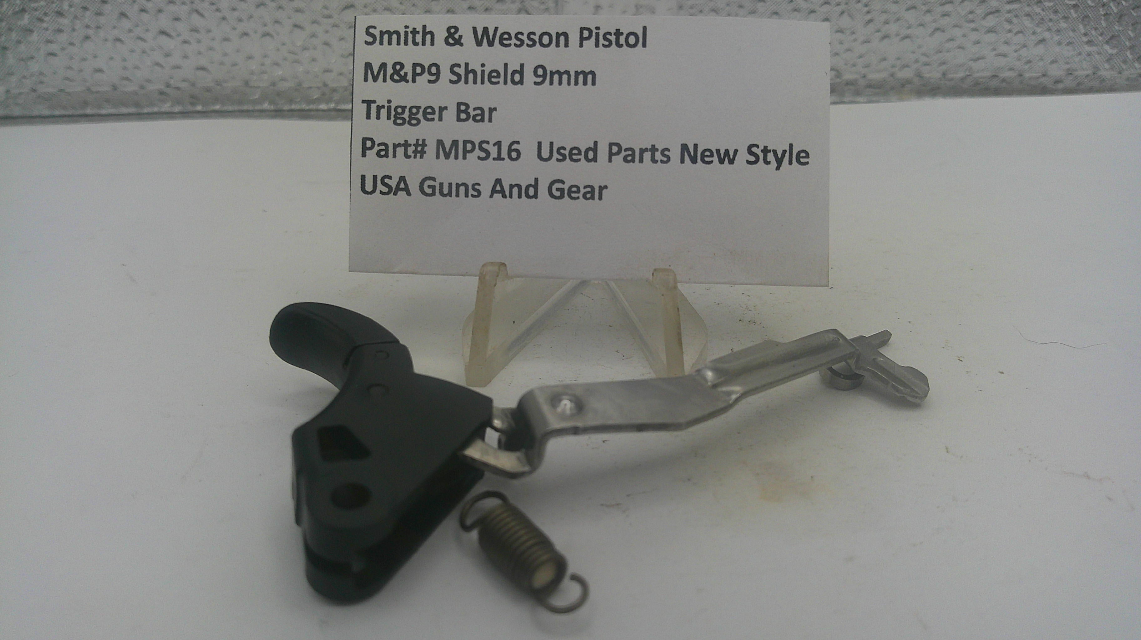 Smith & Wesson M&P9 Shield 9mm pistol trigger bar replacement part, part number MPS16, shown on a white display stand with a handwritten label card.