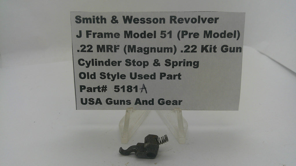 A small black metal cylinder stop and spring part displayed below a white sign that reads 'Smith & Wesson Revolver J Frame Model 51 (.22 MRF .