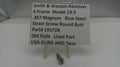 Smith & Wesson revolver part with descriptive sign on a white background