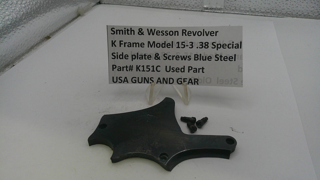 Smith & Wesson revolver parts on a white surface with a label.