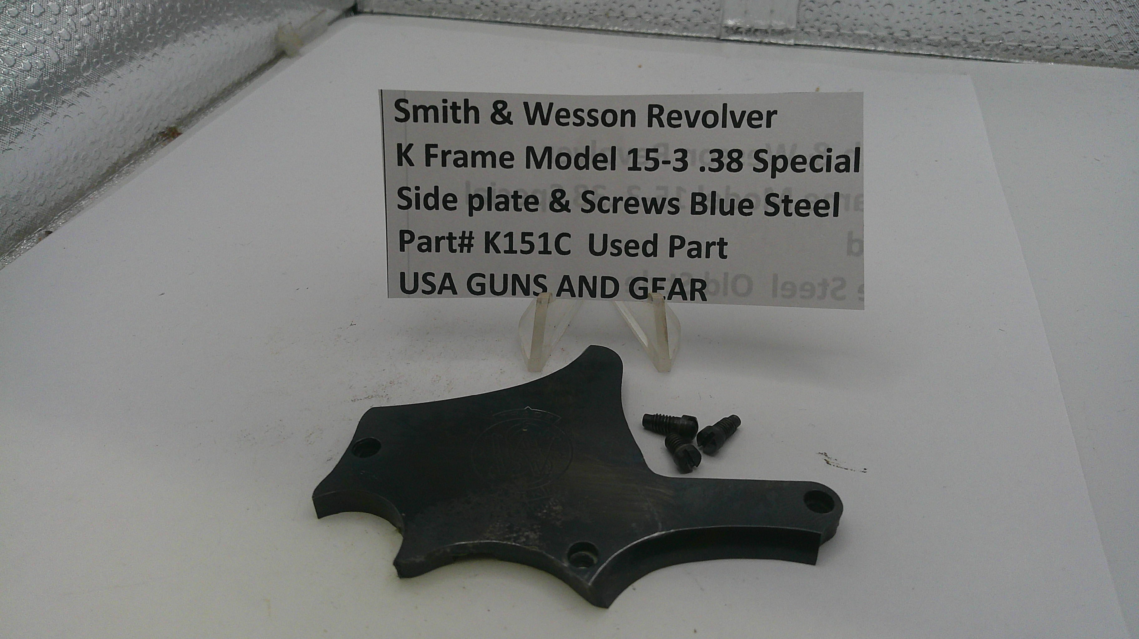Smith & Wesson revolver parts on a white surface with a label.