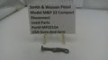 Used parts of a Smith & Wesson pistol on a white surface with a label.
