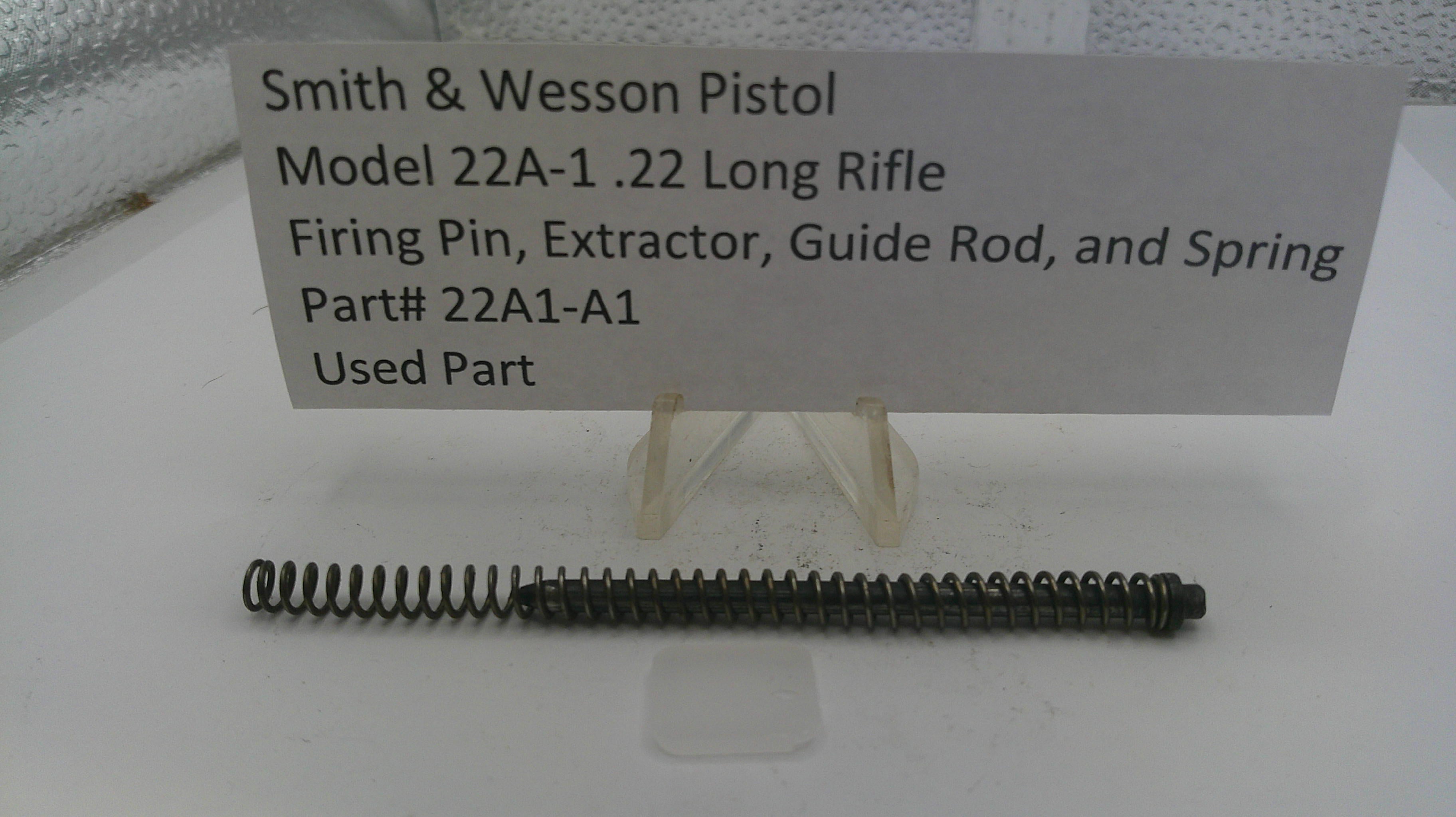 Smith & Wesson pistol part on a stand with a label