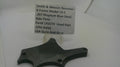 A used metal side plate part for a Smith & Wesson revolver, mounted on a clear plastic display stand with a paper label showing the part details.