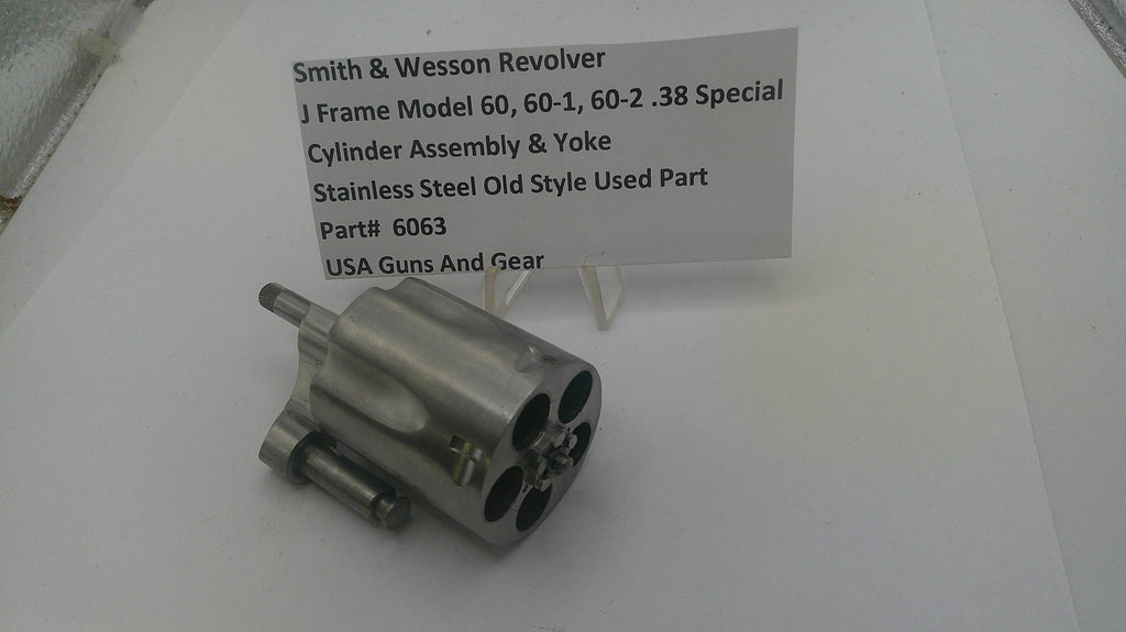 Smith & Wesson revolver cylinder assembly on a white surface with a label