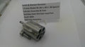 Smith & Wesson revolver cylinder assembly on a white surface with a label