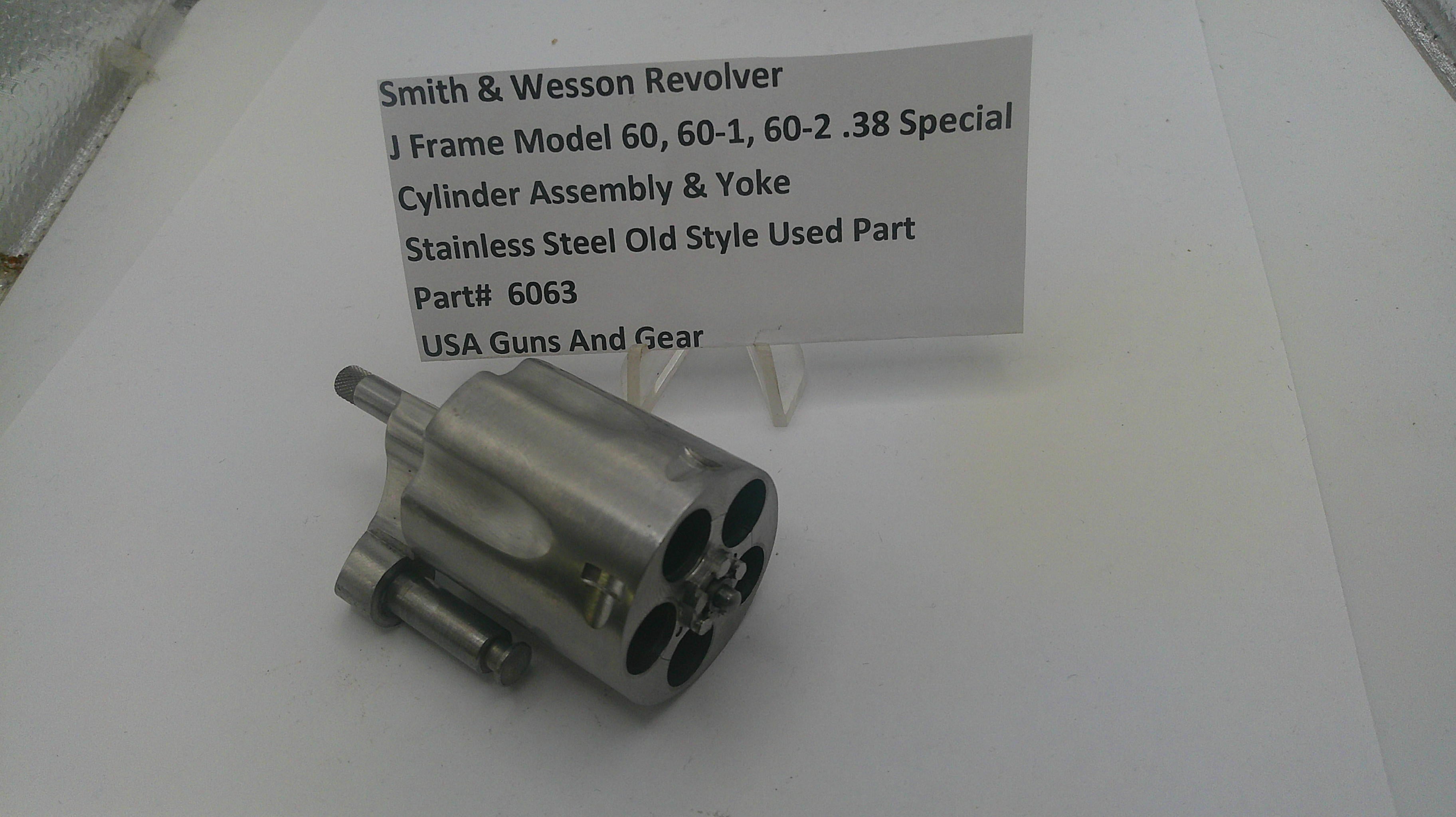 Smith & Wesson revolver cylinder assembly on a white surface with a label