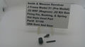 A used metal part set for a Smith & Wesson revolver, displayed on a white surface with a white label card. The parts include a black cylindrical component and two small dark metal pins.