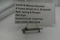 Smith & Wesson revolver part on a stand with descriptive label