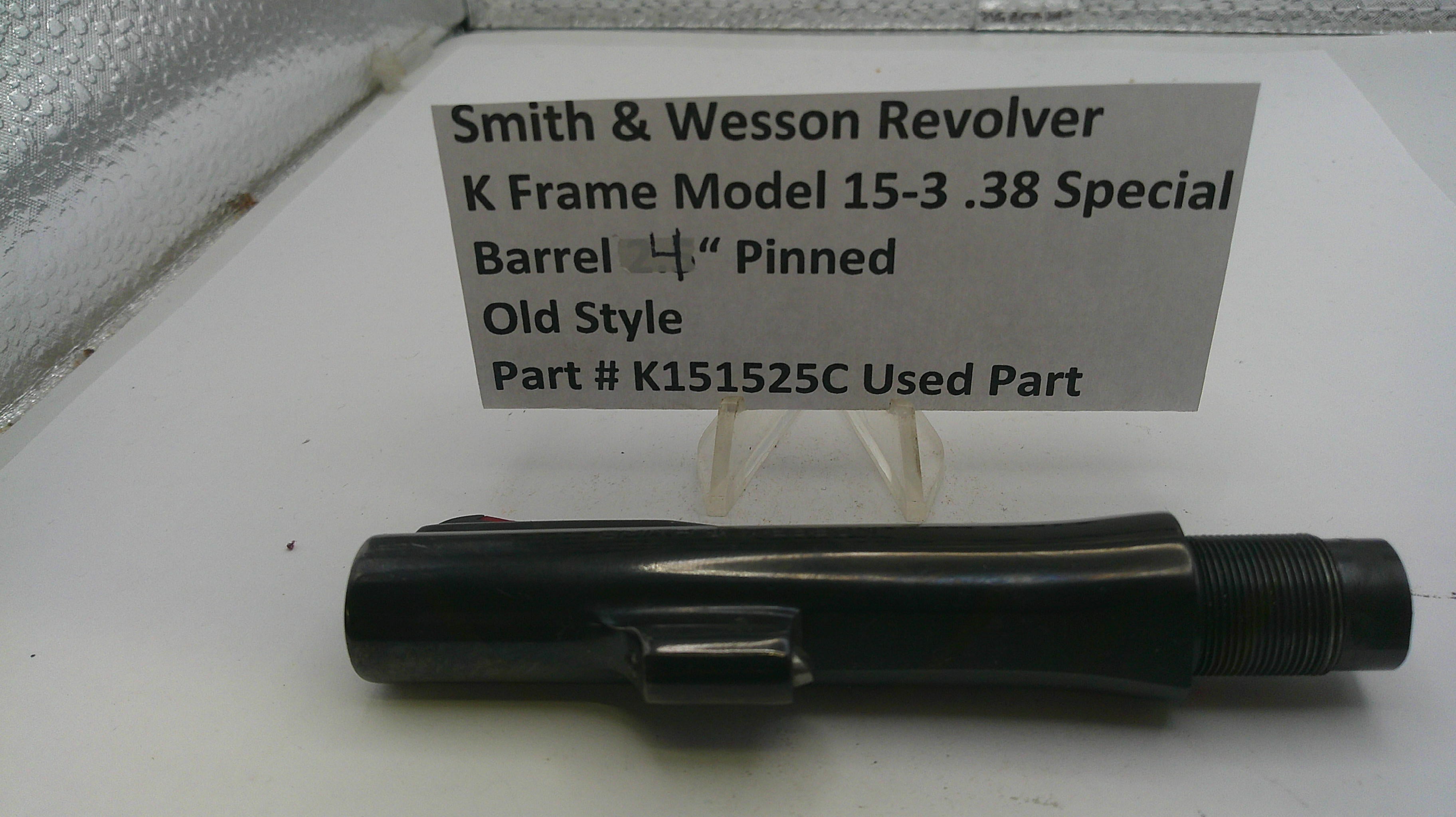 Smith & Wesson revolver barrel on a white surface with a label detailing specifications.