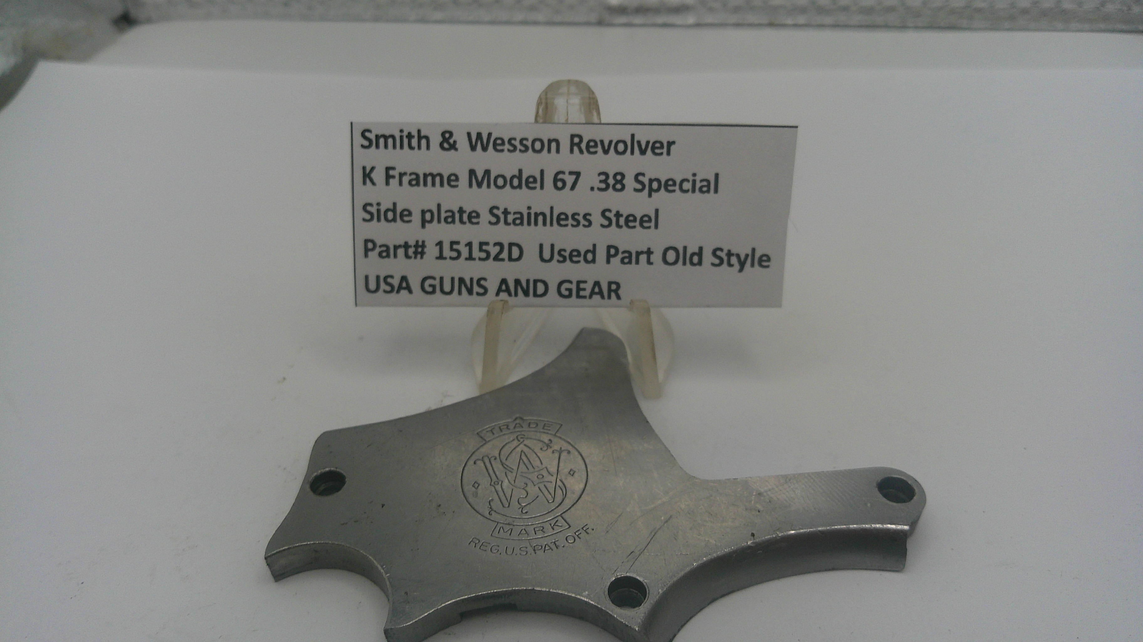 Smith & Wesson revolver side plate on a white background with a label.