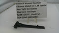 Smith & Wesson revolver rear sight with screws on a white background, accompanied by a label.