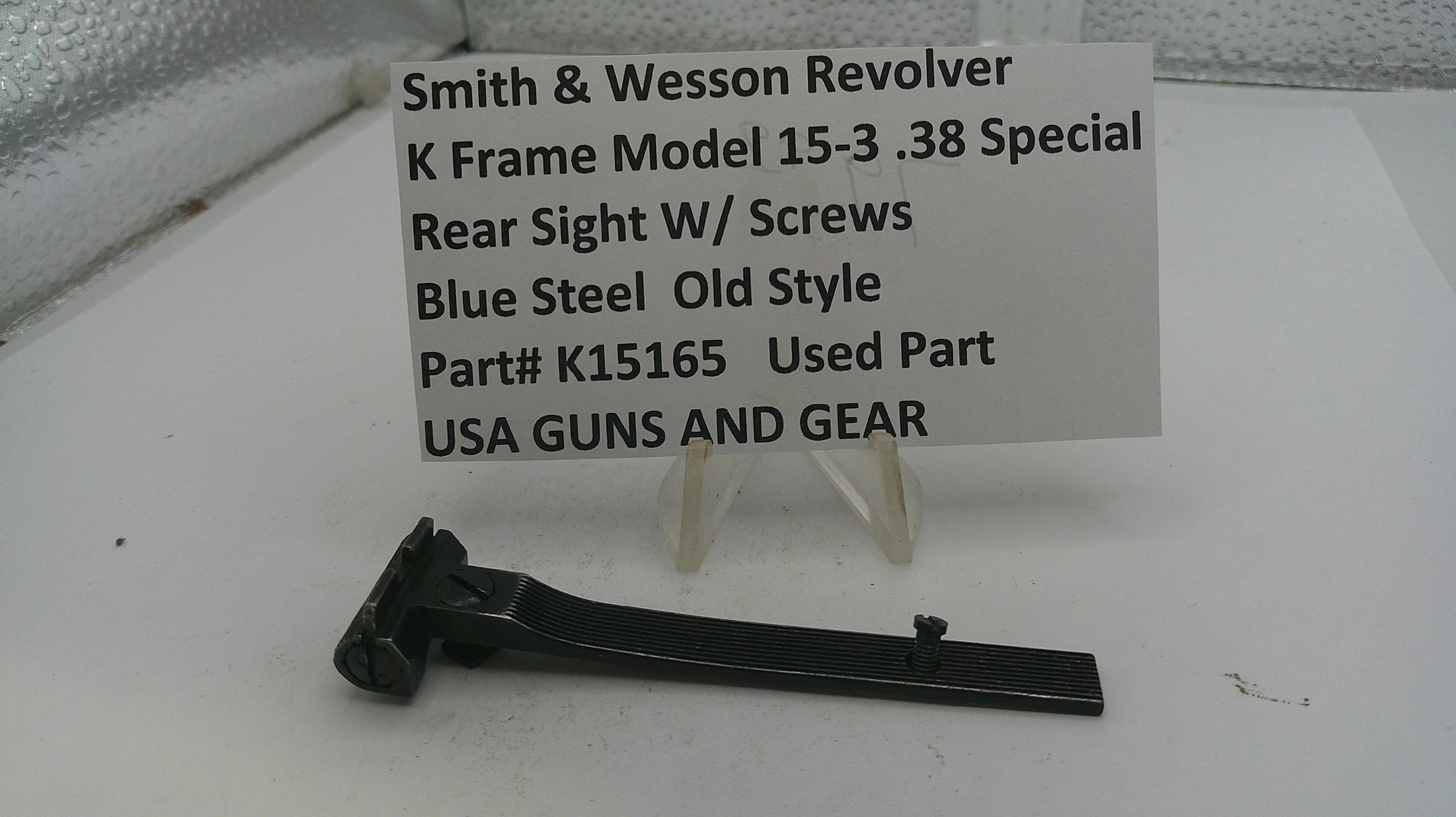 Smith & Wesson revolver rear sight with screws on a white background, accompanied by a label.