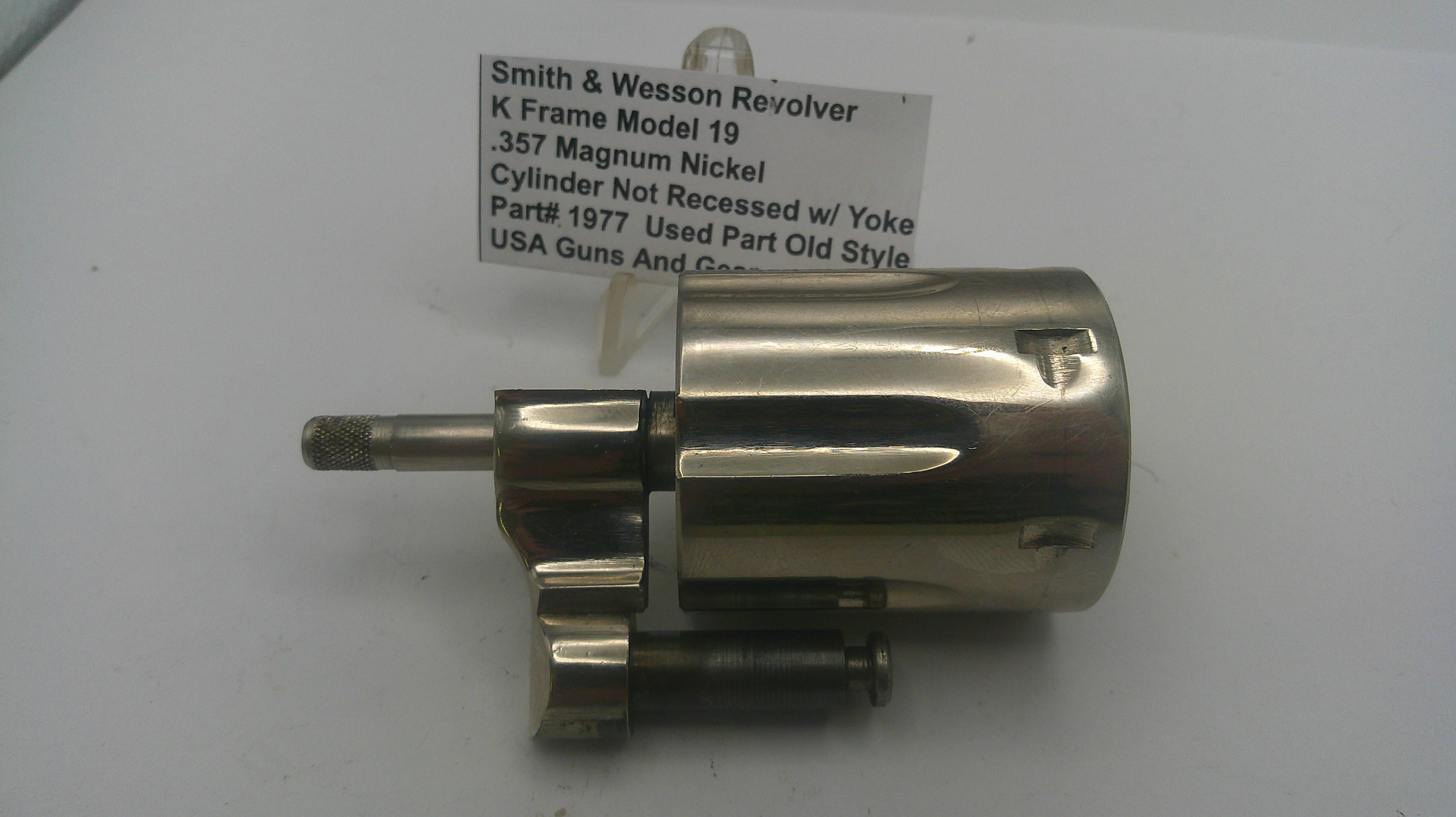 Smith & Wesson revolver cylinder on a white background with a label.