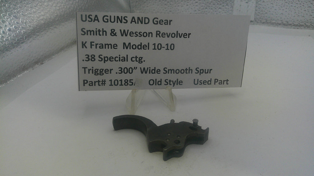 Smith & Wesson Revolver trigger part on a white surface with a label