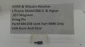 A small metal firearm firing pin part displayed on a clear plastic stand, with a paper label reading 'Smith & Wesson Revolver L Frame Model 686-6 & Higher .357 Magnum Firing Pin Part# 686103 Used Part MIM Only USA Guns And Gear'.