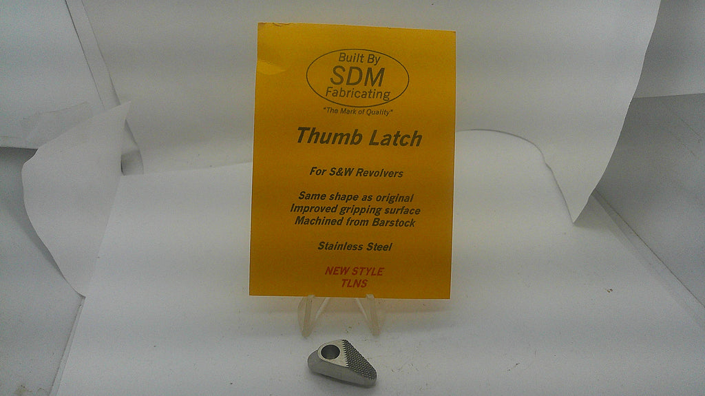 SDM stainless steel thumb latch for Smith & Wesson revolvers, with SDM packaging. Inventory reference 157294.