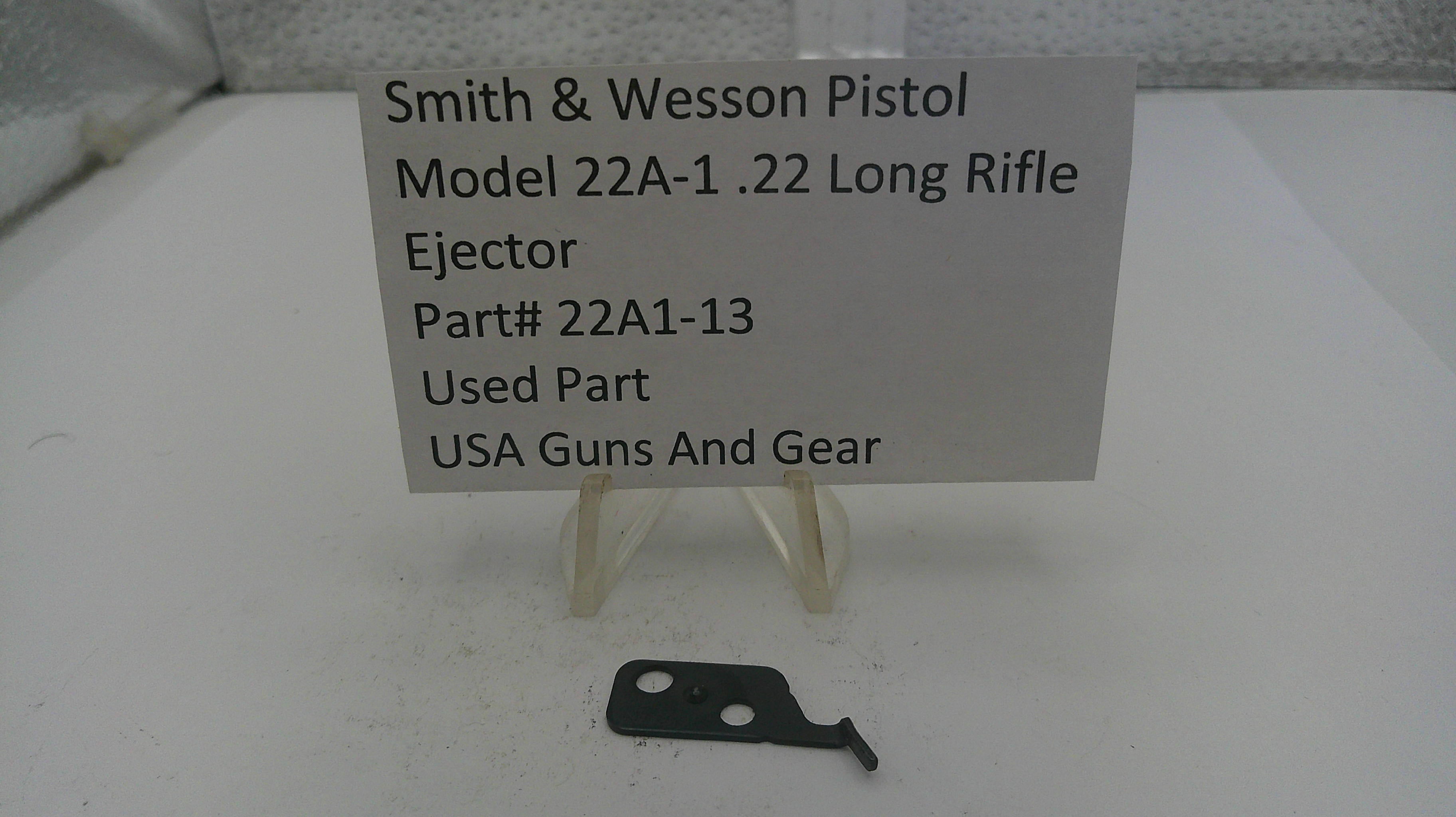 Smith & Wesson pistol ejection part with a label on a white background