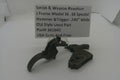 A used metal hammer and trigger assembly for a Smith & Wesson revolver, displayed on a white surface with a paper label card showing the part details.