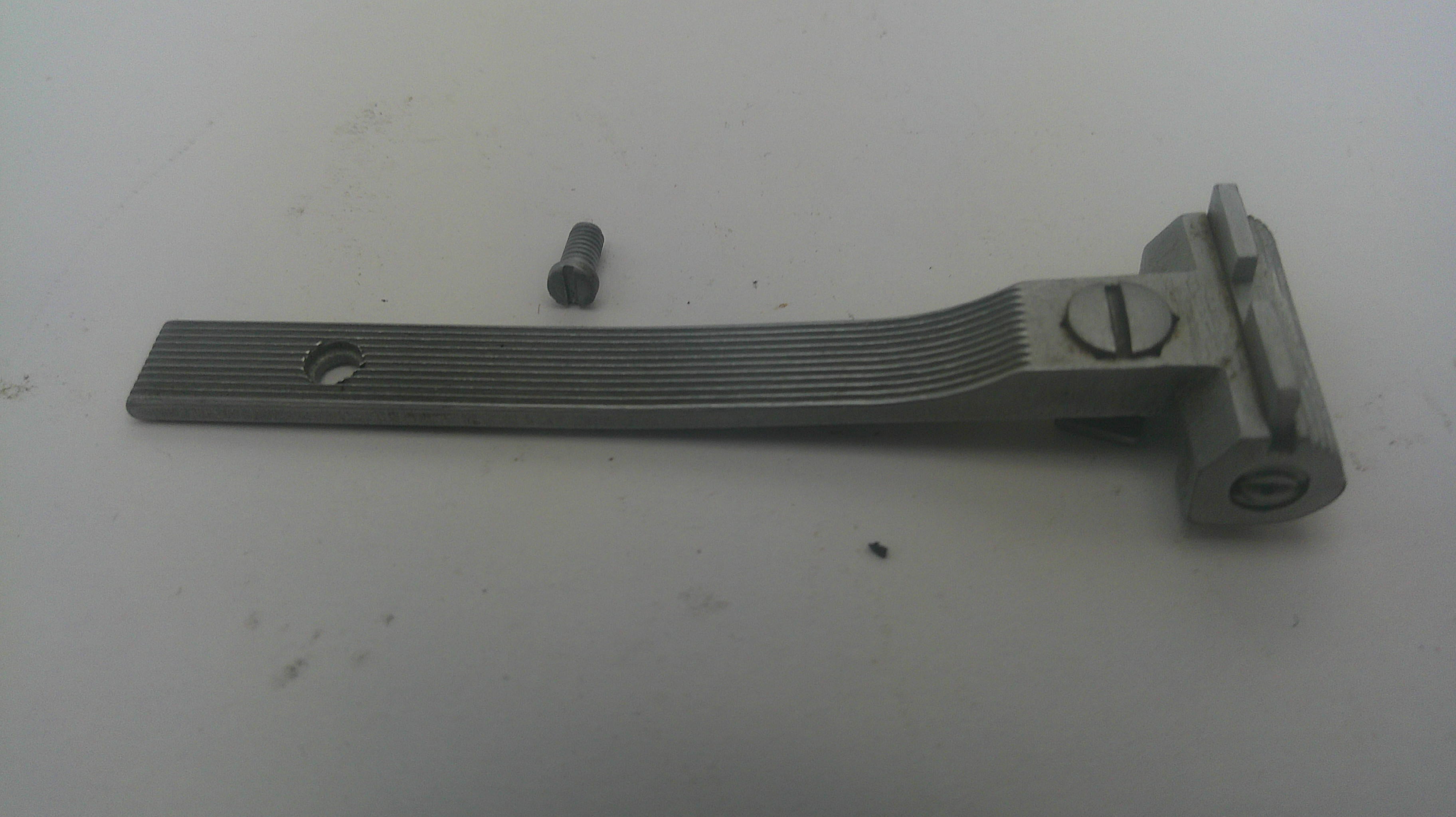 A metal hinge or bracket component with a ribbed flat arm and mounting bracket, shown with a small matching screw on a plain light background.