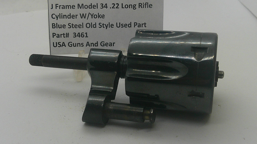 A used black steel J-frame cylinder w/ yoke part for a .22 long rifle, shown next to a white label card with product details.