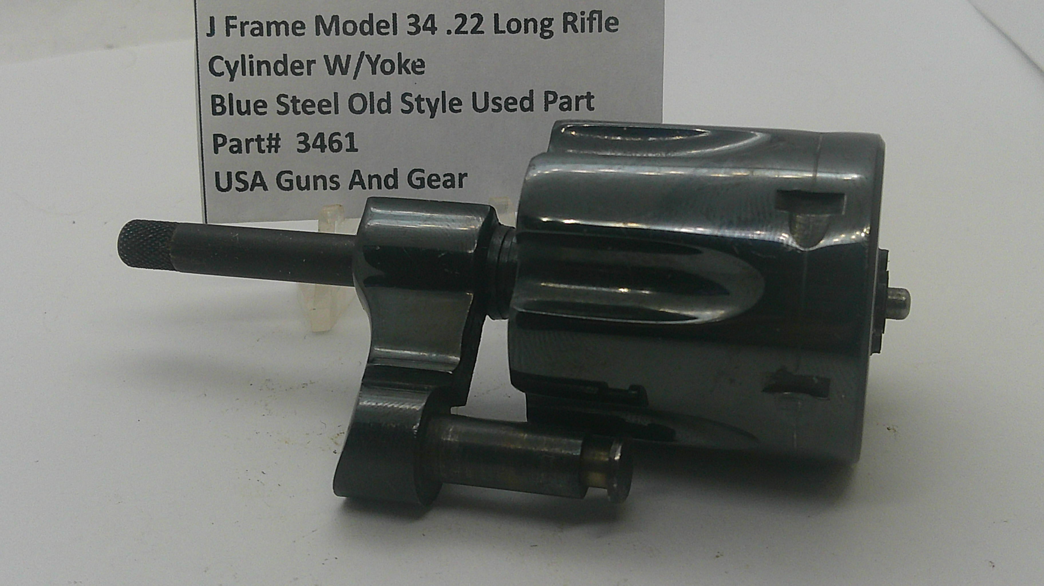 A used black steel J-frame cylinder w/ yoke part for a .22 long rifle, shown next to a white label card with product details.