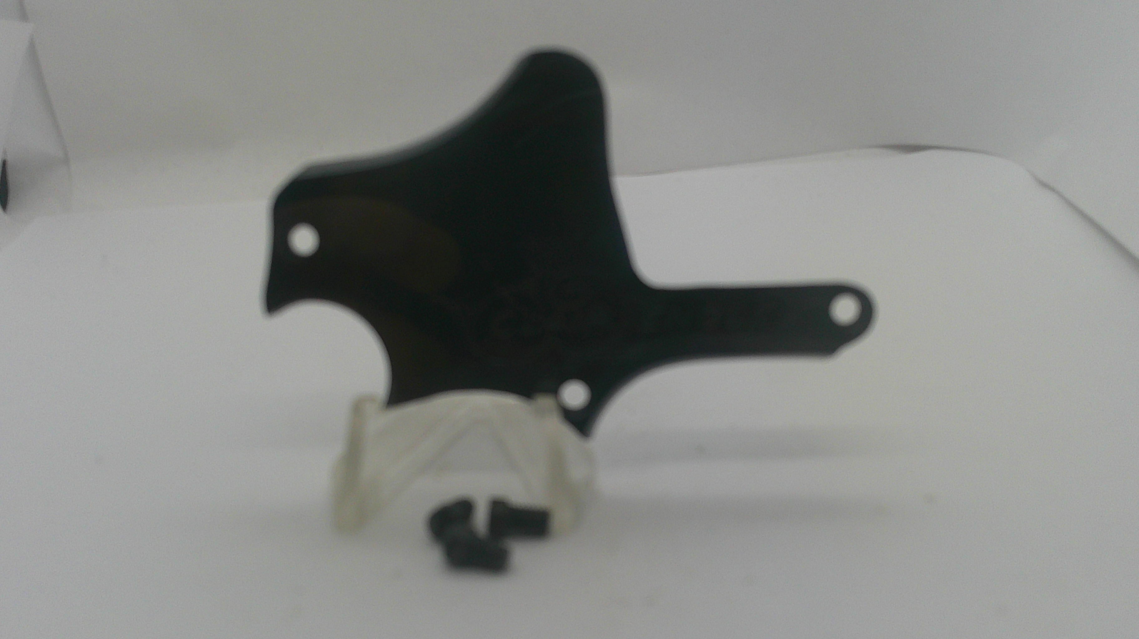 A black plastic guitar pickguard with mounting holes, displayed on a white surface with a small white plastic clip and black screws in front.