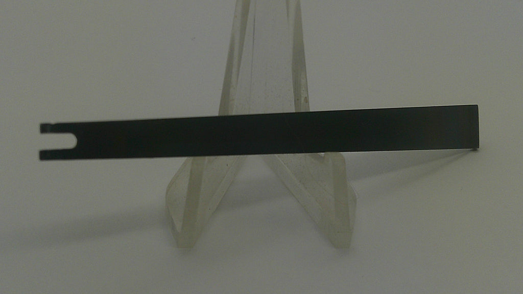 A long, thin black metal bar with a notch on one end, displayed horizontally on a clear plastic stand against a plain light background.