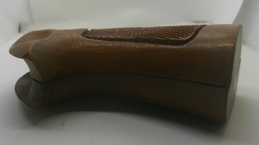 A brown wooden gunstock grip with a textured grip panel and a darker wood base, shown on a plain white background.