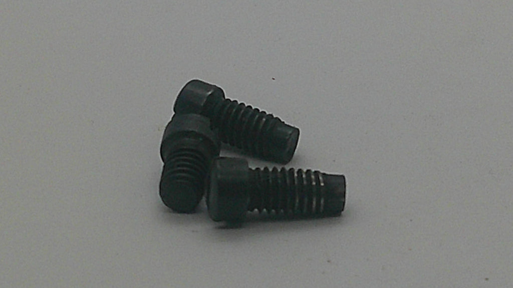 Three small black metal screws with threaded shafts and rounded heads, arranged on a plain light gray surface.