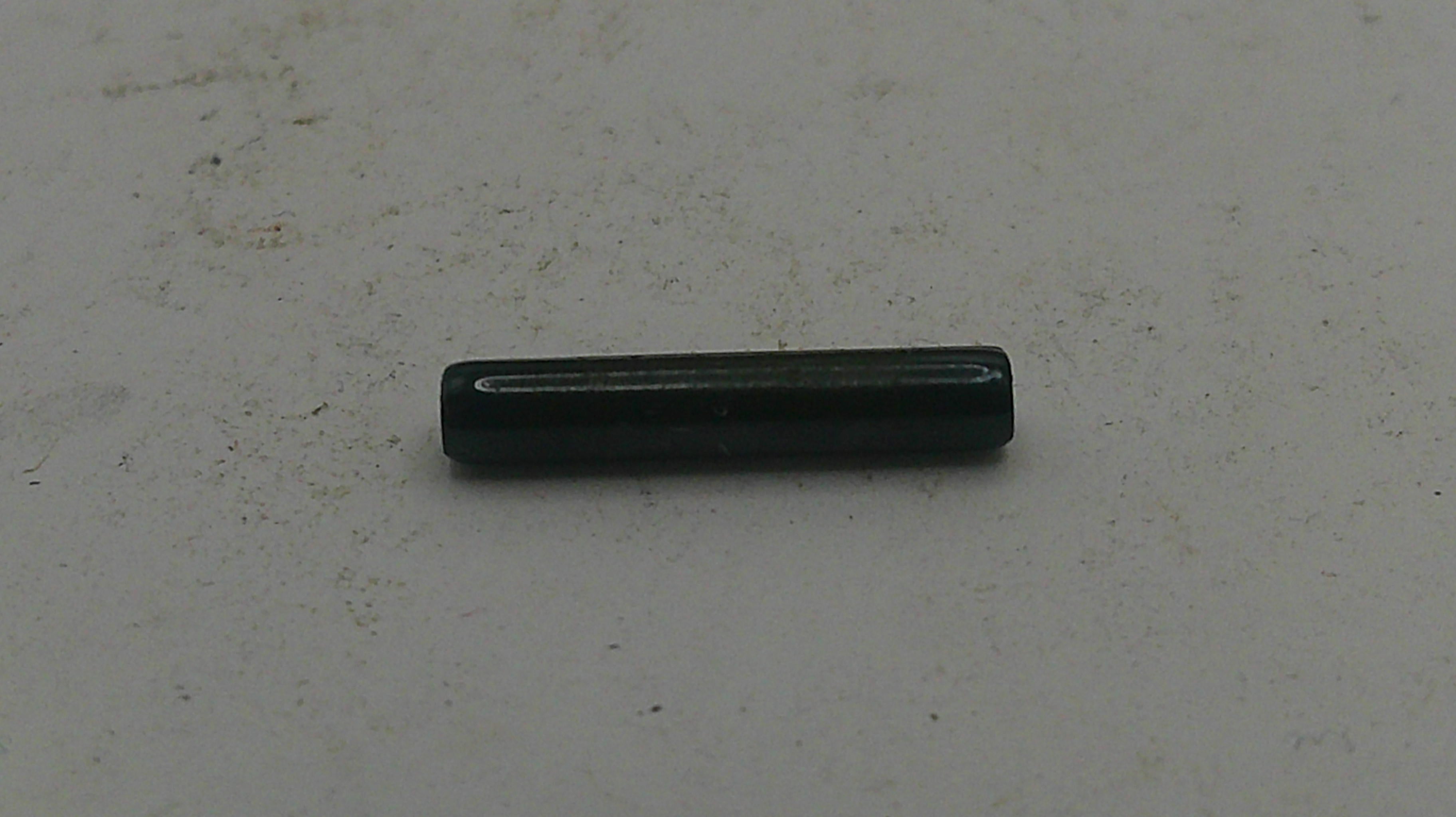 Black cylindrical object on a light gray background